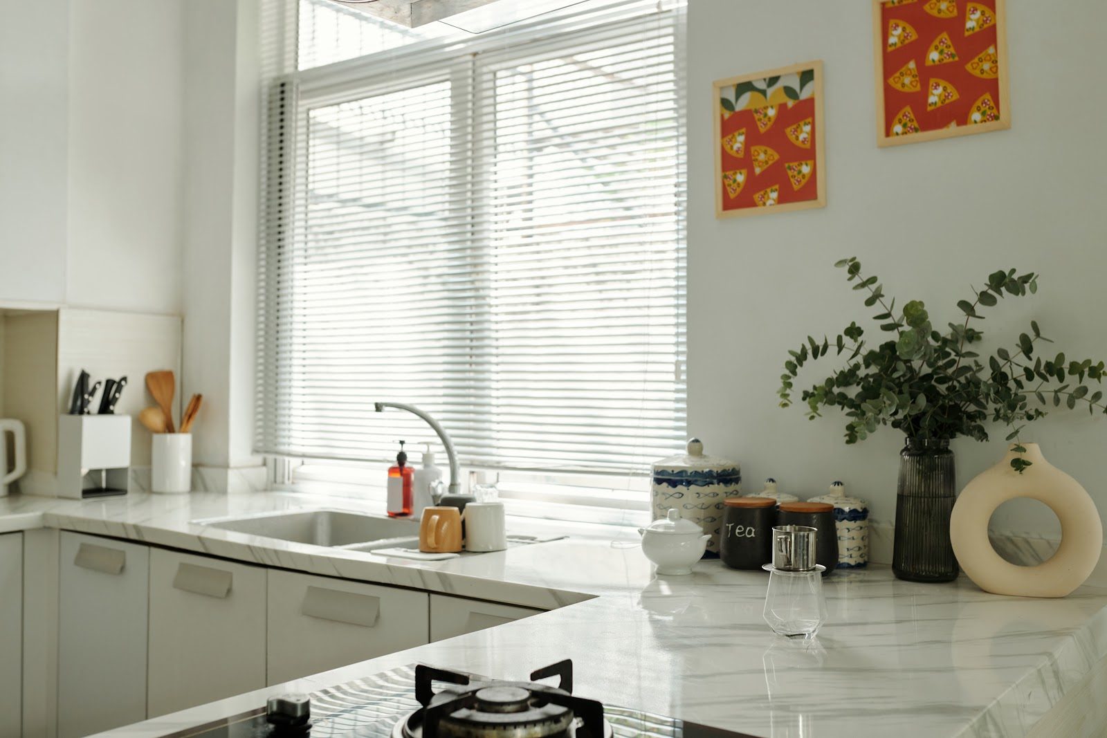Venetian blinds on a bright kitchen window