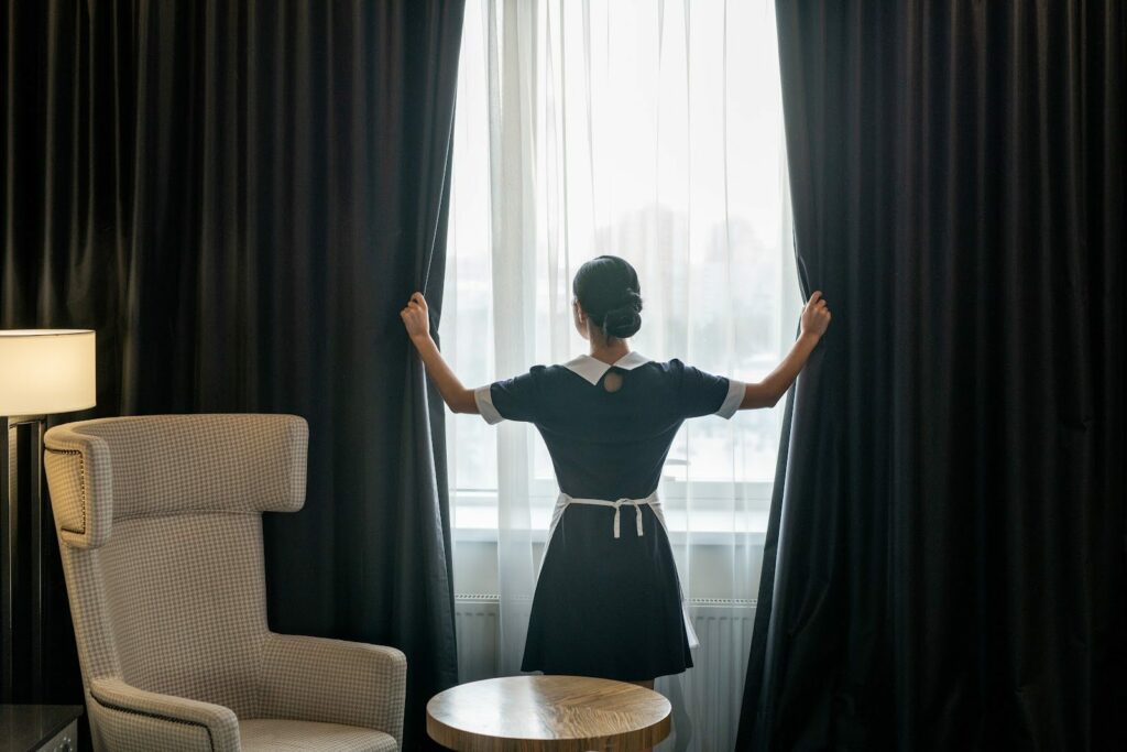 Blackout curtains being opened in a bedroom